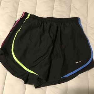 Small black Nike athletic shorts with blue green red and purple.